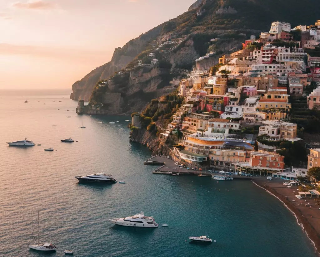 Aerial sunset view of Positano on the Amalfi Coast, luxury Italy travel.
